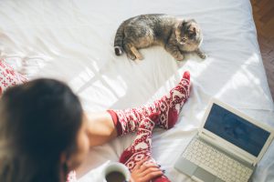 Girl enjoying her morning coffee with her cat